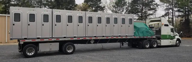 Long multi-door shower trailer loaded for delivery