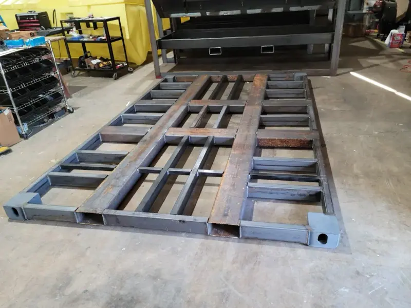 A steel floor frame laid out in the shop before assembly