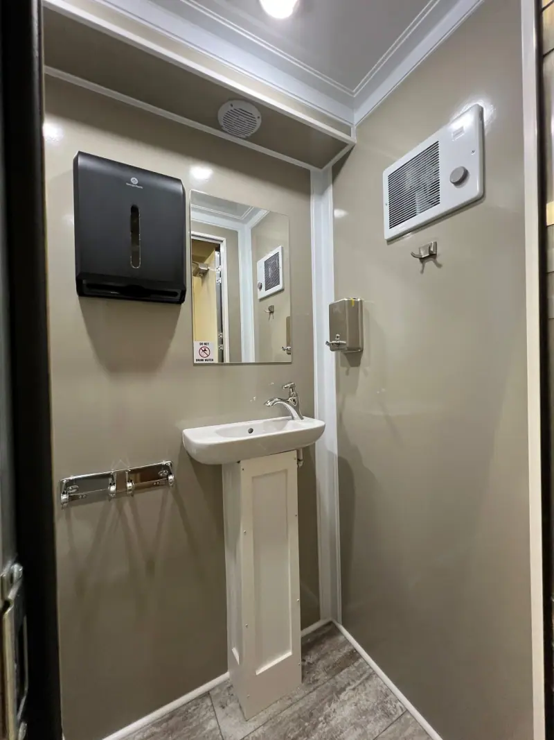 Middle room of a four-room restroom trailer with a wall-mounted dispenser