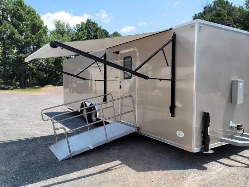 Shower trailer with a roll-out awning and an aluminum ramp with railings