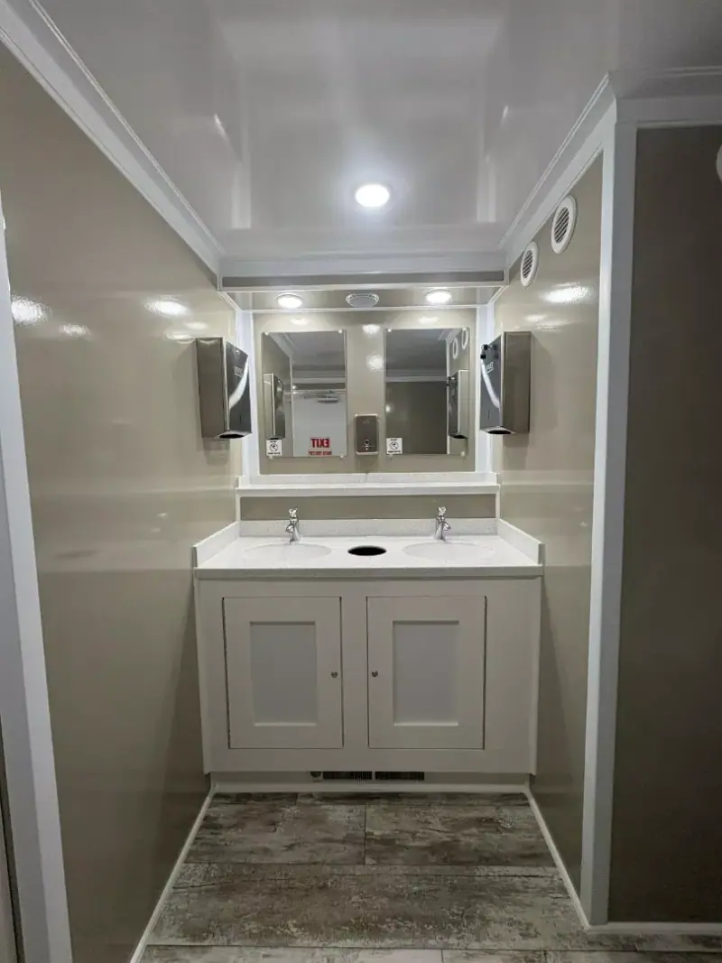 Men’s suite vanity with two sinks and mirrors in a brownstone finish
