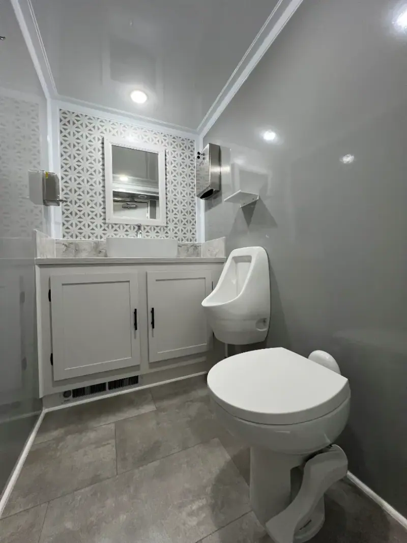 Andover luxury package interior with a framed mirror and urinal