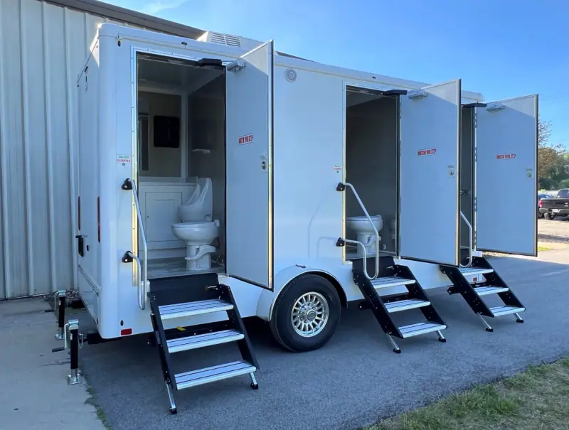 Three-door restroom trailer with fold-down steps