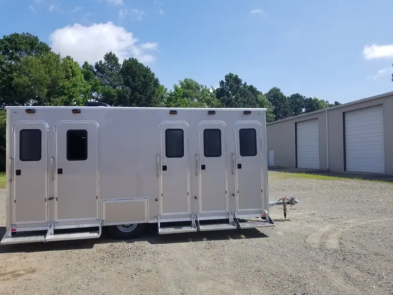 Shower and restroom combo trailer with six doors and fold-down steps