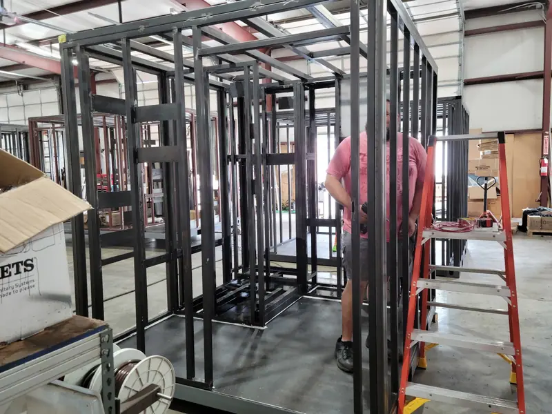 Welding a steel wall frame on the shop floor