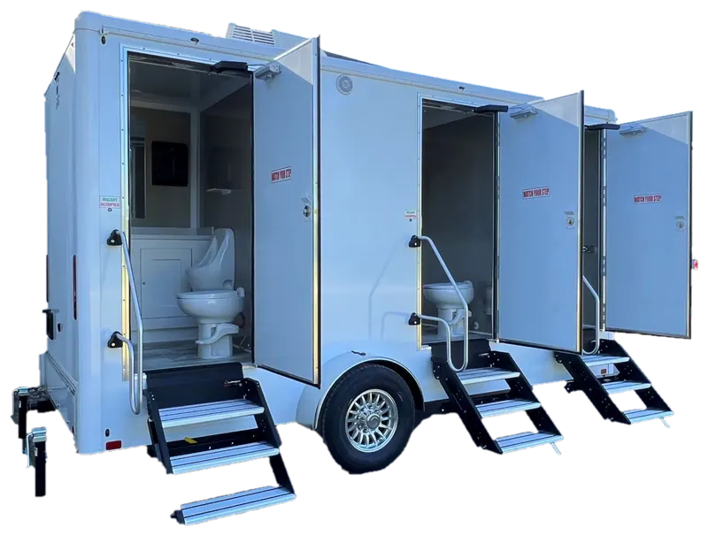 Three-door shower and restroom trailer with open doors and fold-down steps