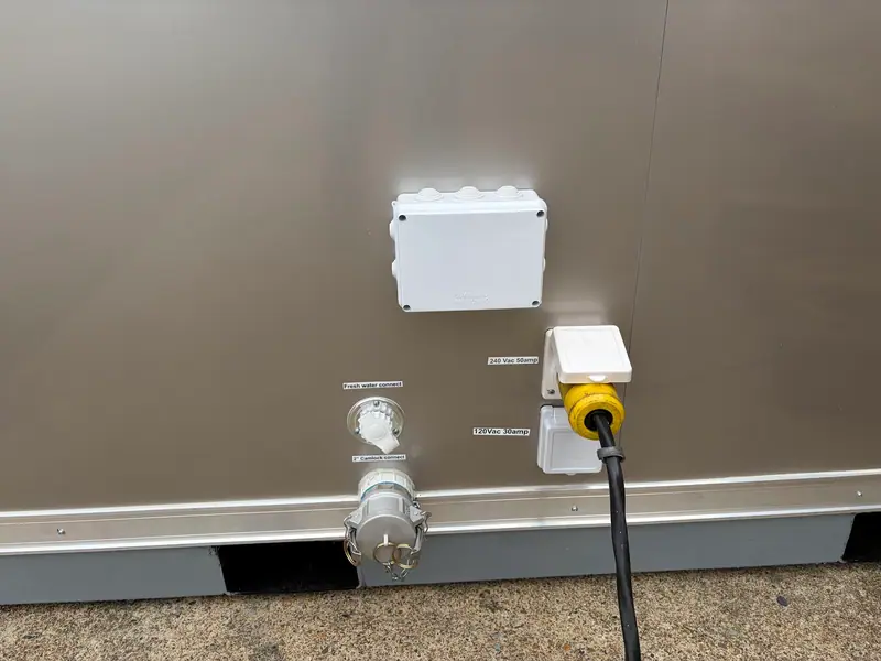 Water and power hookups on the side of a trailer