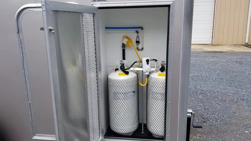 Propane tanks for on-demand hot water in the equipment bay