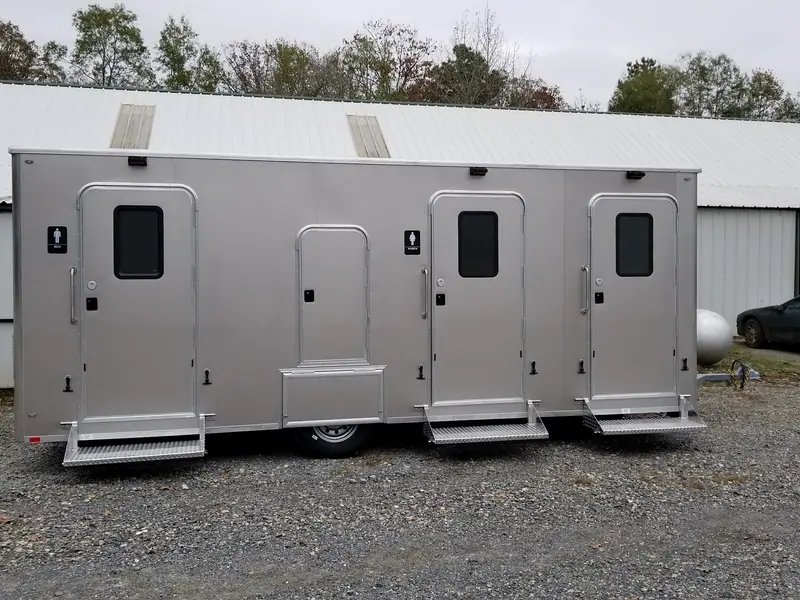 Three-door restroom trailer with men’s and women’s rooms