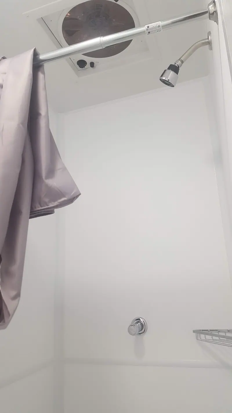 Shower with an overhead rain head and a curtain