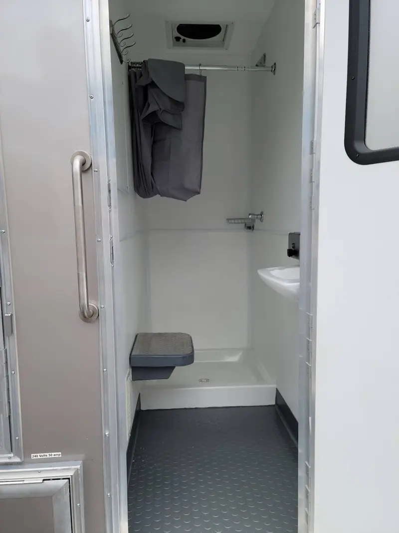 Shower stall with a grab bar and a fold-down seat
