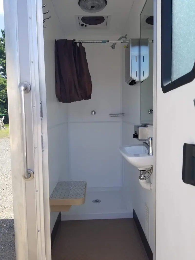 Shower room with a fold-down seat, a sink and a mirror