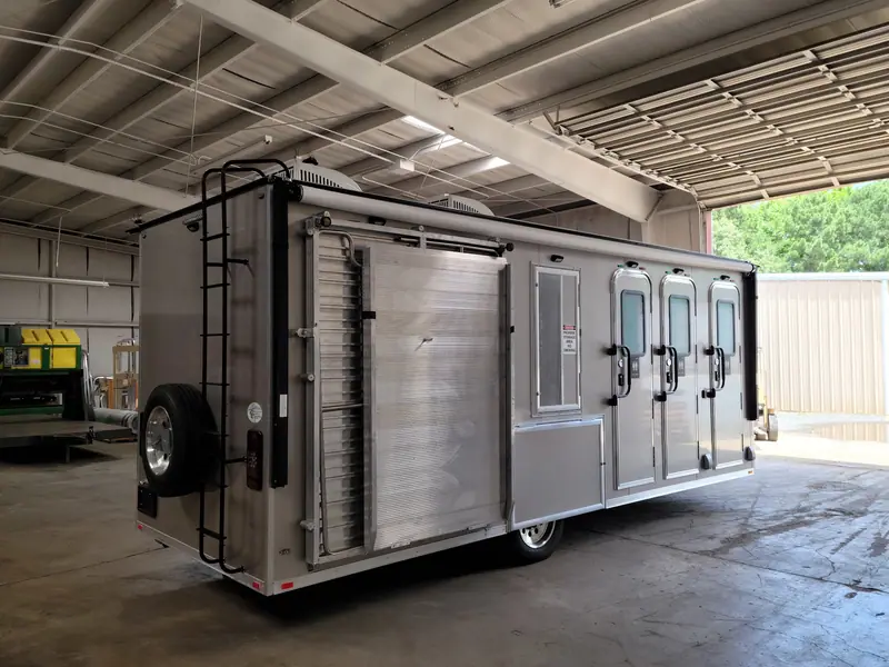 Shower trailer with a roof ladder and a spare tire inside the plant