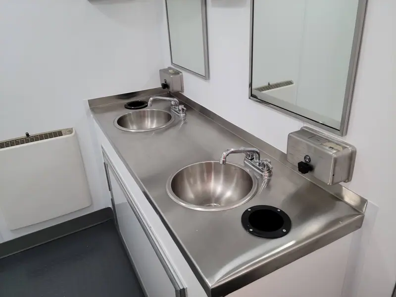 Stainless steel vanity with two sinks and mirrors