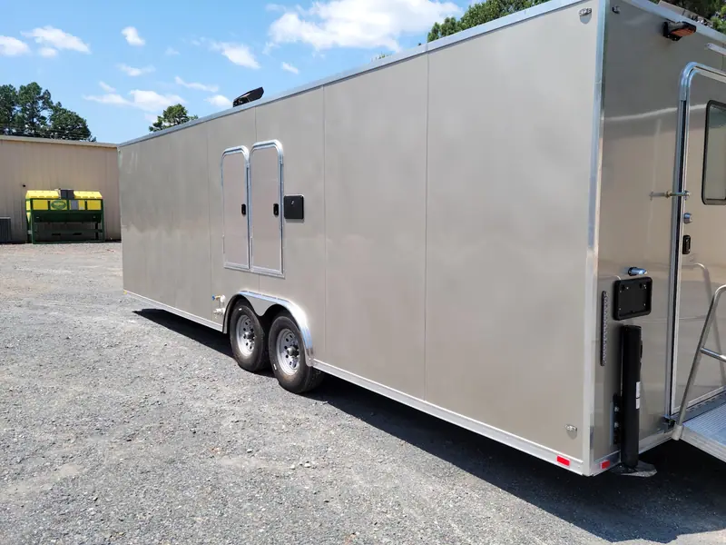 Long tandem-axle shower trailer on a gravel lot