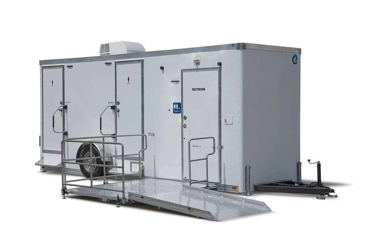 The ADA+4 Restroom Trailer offers multiple doors, metal handrails, and an access ramp, making it ideal for events or construction sites.