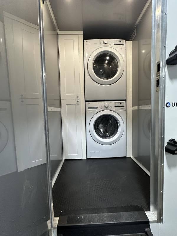 A 2 private room shower restroom trailer is set up in a clean, narrow space with amenities on either side for convenience and privacy.